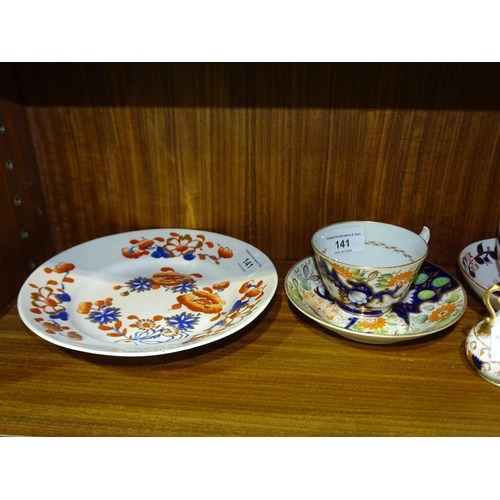 141 - A late-19th century Crown Derby cup and saucer with Imari-style leaf decoration and other pieces of ... 