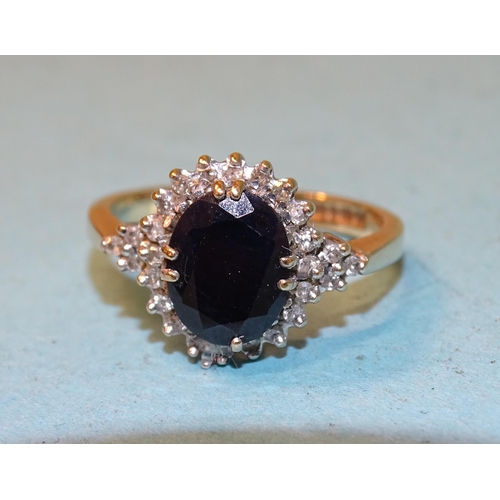 104 - A sapphire and diamond cluster ring claw-set an oval sapphire within a border of 8/8-cut diamonds, i... 