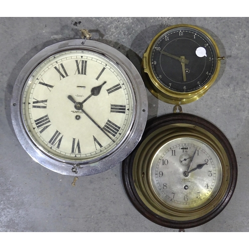 49 - A brass bulk-head clock with silvered dial marked Barkers, Kensington, 23cm diameter, movement opera... 
