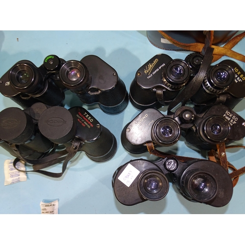 82 - A collection of seven pairs of binoculars, including Dollond 10x50 Field, Hilkinson 10x50 Field, Rus... 