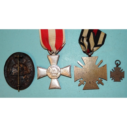 219 - An Imperial German Hamburg Hanseatic Cross, a 1914-18 Honour Cross with miniature and a WWI wound ba... 