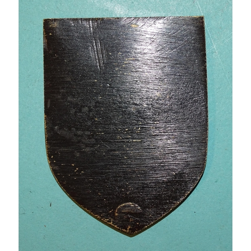 222 - A cast metal example of the Warsaw Shield, 7.2 x 5.4cm.