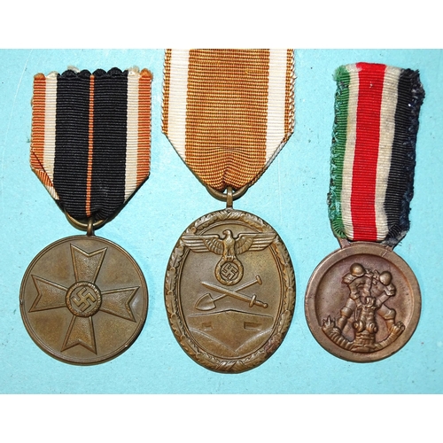 232 - Three German WWII medals: African Campaign, West Wall and Merit, (3).