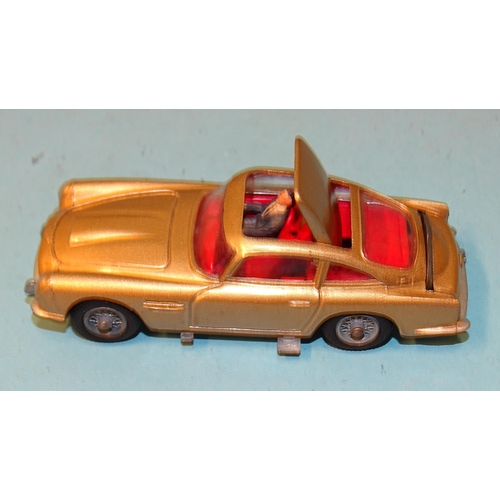 241 - Corgi Toys, no.261 James Bond's Aston Martin D.B.5, gold body, red interior, driver, (no baddies), b... 