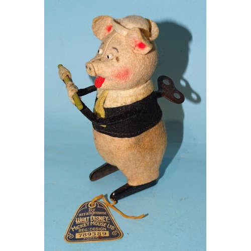 285 - A Schuco for Walt Disney c/w felt-covered tinplate pig playing a flute c1930's, 12cm high, with orig... 