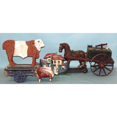 286 - A collection of wooden toys: a pull-along Folk Art cow, a pull-along horse and bowser, a pair of oxe... 