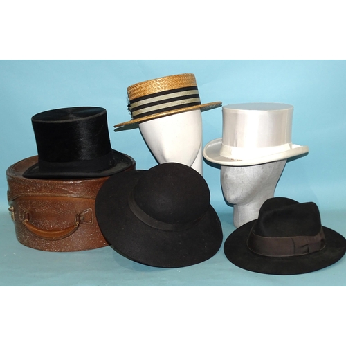 444 - A straw boater, a top hat (worn), a white satin top hat and two felt hats, (5).