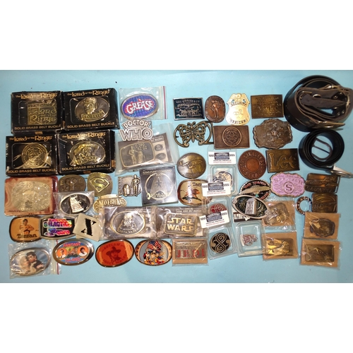 458 - A large quantity of brass and other buckles and belts, many relating to cinema and tv.... 