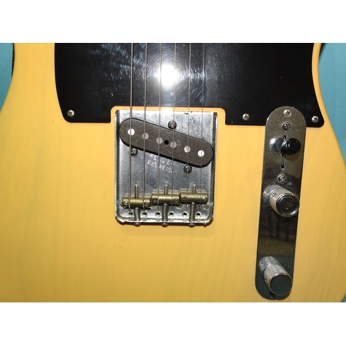 468 - A similar electric guitar, made in Mexico, with cream and black body, (wear to centre of back), no.M... 