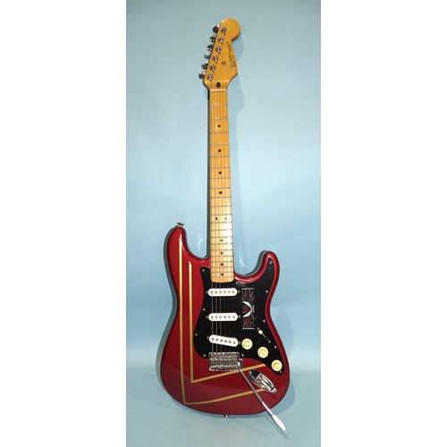 472 - A similar guitar, with striped metallic red and black body, made in Mexico, no.MN4150556.... 