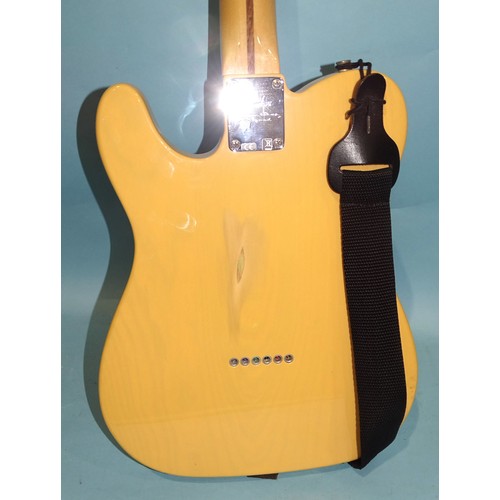 468 - A similar electric guitar, made in Mexico, with cream and black body, (wear to centre of back), no.M... 