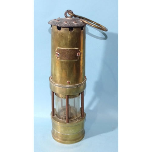 389 - J H Naylor Ltd, Wigan, a brass and iron miner's safety lamp engraved D T Owen, 37cm high (including ... 