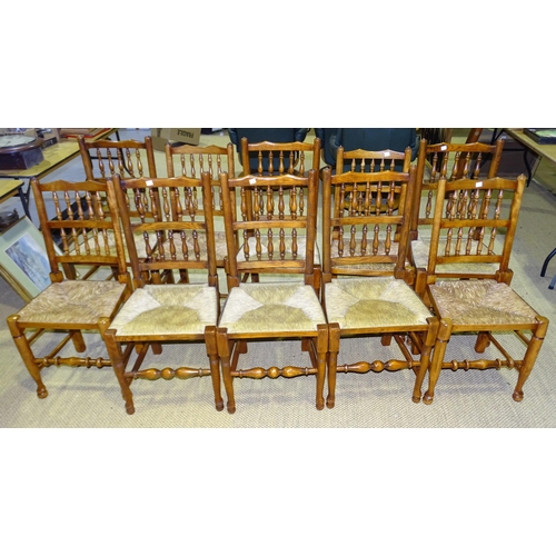 29 - A harlequin set of ten reproduction stained wood country dining chairs with spindle backs and rush s... 