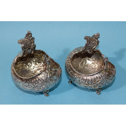 627 - A pair of Continental silver salts of bulbous boat shape, each raised on three scroll feet, London i... 