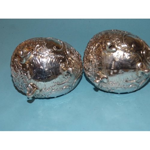 627 - A pair of Continental silver salts of bulbous boat shape, each raised on three scroll feet, London i... 