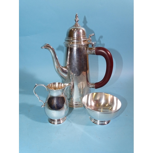 630 - A modern silver chocolate pot of plain tapered form, London 1975, 21.5cm high, together with a cream... 