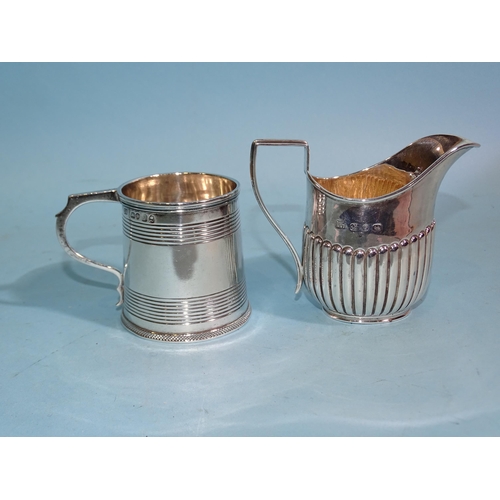 633 - An early-19th century tankard-shaped christening mug with bands of reeding, London 1824, 6cm high an... 