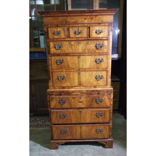 7 - A small walnut inlaid and banded chest on chest in the 18th century style, the cornice above three s... 