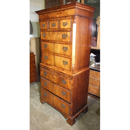 7 - A small walnut inlaid and banded chest on chest in the 18th century style, the cornice above three s... 