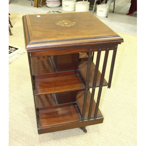 14 - An Edwardian inlaid mahogany revolving bookcase, 52cm square, 87cm high, (some damage to struts).... 