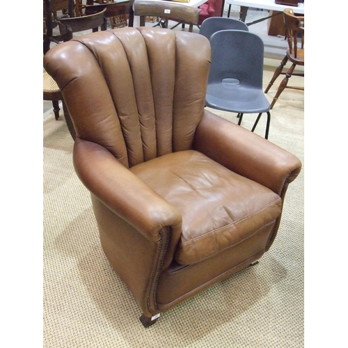 28 - A modern leather-upholstered armchair.