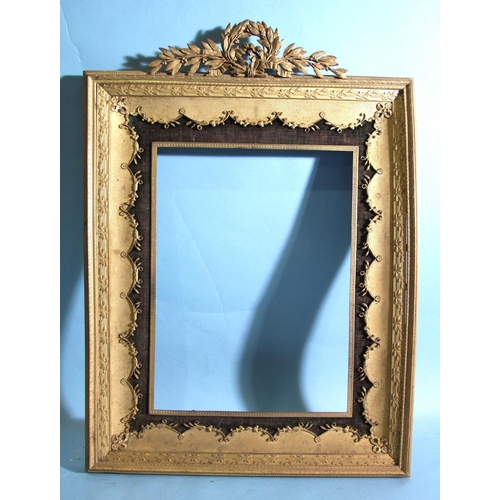 72 - A late-Victorian gilt-metal frame of beaded and foliate design surmounted by a laurel wreath, 35 x 4... 