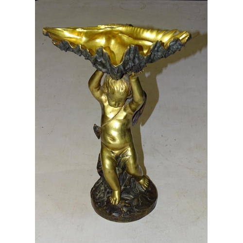 101 - A gilt and bronze tazza in the form of a winged cherub supporting a clam shell, on circular base, 32... 