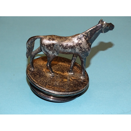 203 - A small plated car mascot in the form of a horse, 7.5cm high, base 6cm diameter.