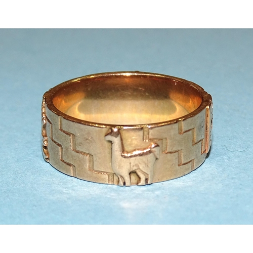 240 - A gold ring with raised Inca symbols, size U, marked '18k', 10.3g.