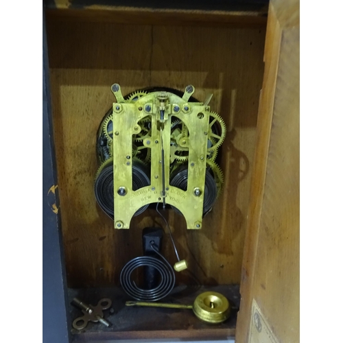 90 - An Ansonia Clock Co. oak-cased clock of architectural design striking on a gong, with paper label 'E... 