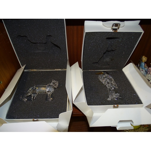 70 - A Swarovski crystal glass heron, (7670 000 001) and a tiger (7610 000 003), both in original boxes a... 