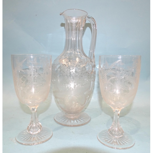 76 - An etched glass wine jug decorated with ferns, leaves and a monogram 