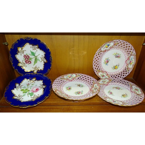 84 - A pair of 19th century cabinet plates, each centrally-painted with flowers within a deep blue and gi... 