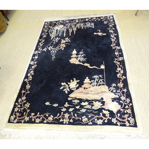 14 - A Chinese rug decorated with prunus on a black ground, 270 x 170cm.