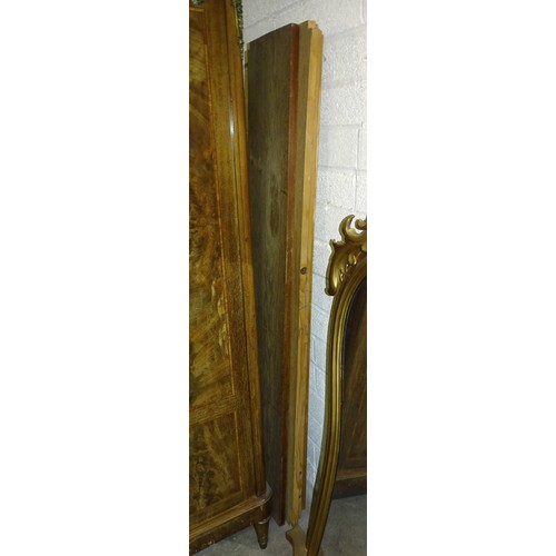 44 - A late-19th century French walnut cross-banded three-door wardrobe, the central door with silk-lined... 