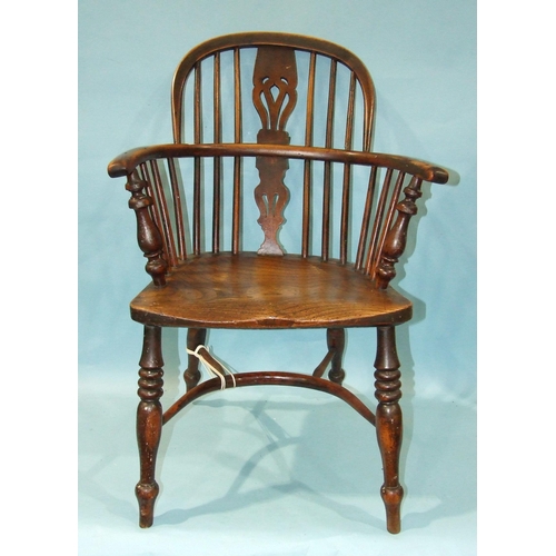 59 - A 19th century yew wood and elm-seated Windsor chair with solid seat, on turned legs with crinoline ... 