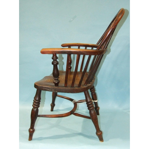 59 - A 19th century yew wood and elm-seated Windsor chair with solid seat, on turned legs with crinoline ... 