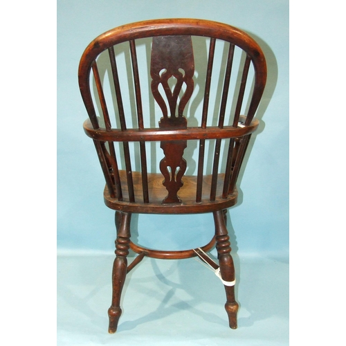 59 - A 19th century yew wood and elm-seated Windsor chair with solid seat, on turned legs with crinoline ... 