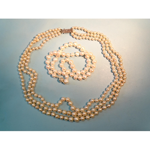 243 - A necklace of three strings of graduated cultured pearls, 4.5mm - 8mm with marcasite set silver clas... 