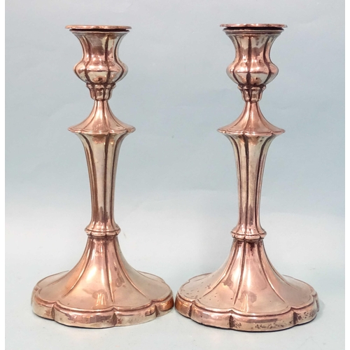 357 - A pair of Edwardian silver loaded candlesticks on flared lobed stems and bases, 22cm high, Walter La... 