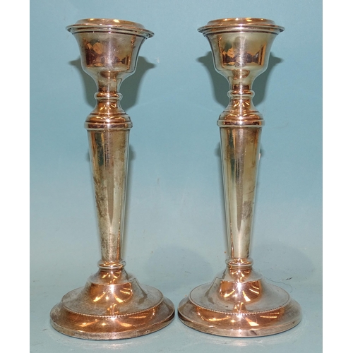 373 - A pair of modern silver candlesticks with loaded bases, 19cm high, Birmingham 1963.