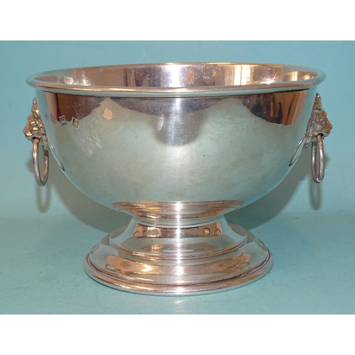 374 - A modern silver rose bowl of plain form, with lion's mask ring handles and raised on circular steppe... 