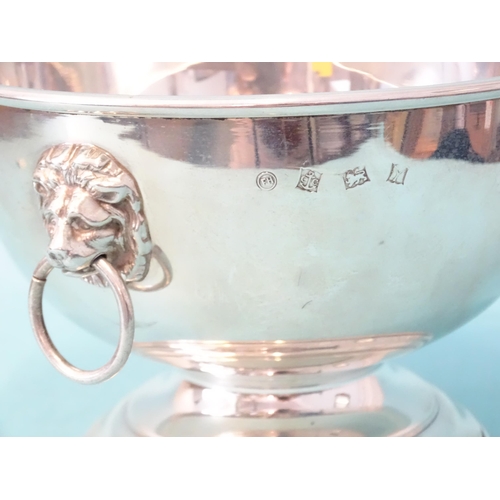 374 - A modern silver rose bowl of plain form, with lion's mask ring handles and raised on circular steppe... 