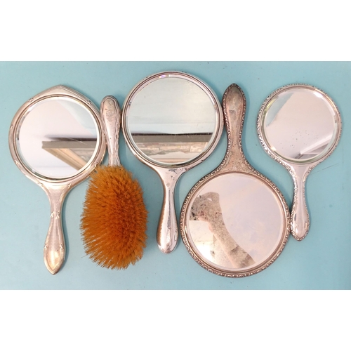 377 - A silver-backed brush and mirror, Birmingham 1910 and three other silver-backed mirrors, various dat... 