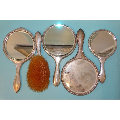 377 - A silver-backed brush and mirror, Birmingham 1910 and three other silver-backed mirrors, various dat... 