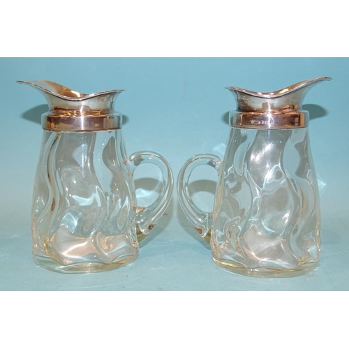 388 - A pair of George V silver-mounted glass whisky water jugs, 13.5cm high, Birmingham 1912, maker Porte... 