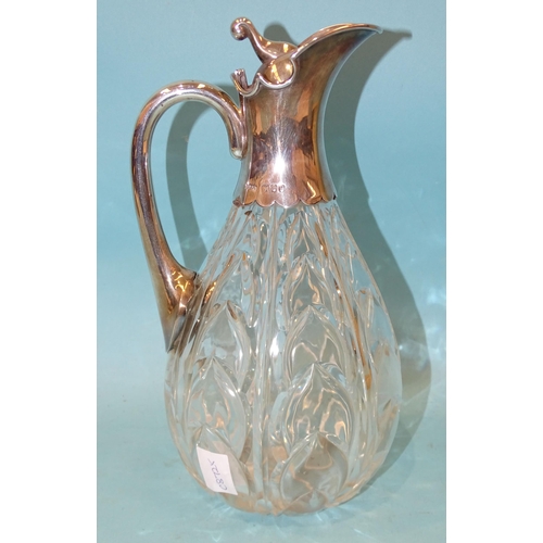 389 - A late-Victorian cut-glass and silver-mounted claret jug, the ovoid body with cut arabesques, the hi... 