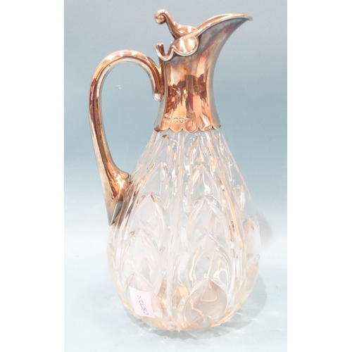 389 - A late-Victorian cut-glass and silver-mounted claret jug, the ovoid body with cut arabesques, the hi... 