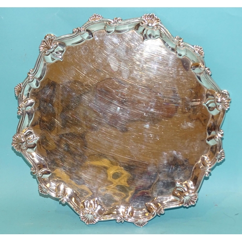 390 - A George III silver salver with waved shell and scroll border, on three hoof feet, 33cm diameter, Lo... 