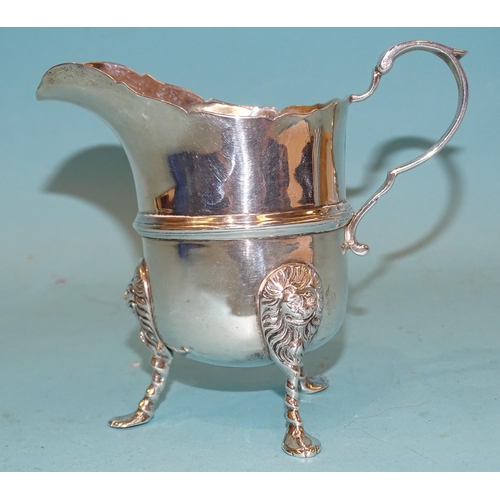 400 - An Edwardian silver cream jug on three lion mask and paw feet, 11cm high, Dublin 1916, maker Charles... 